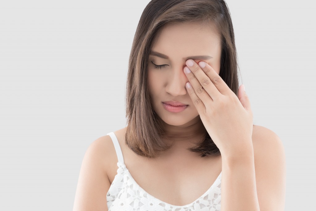 woman touching her eye