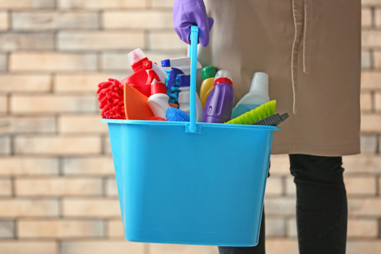 person holding cleaning products