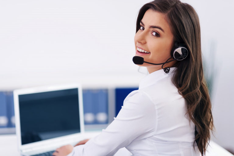 woman wearing a headset working at the office