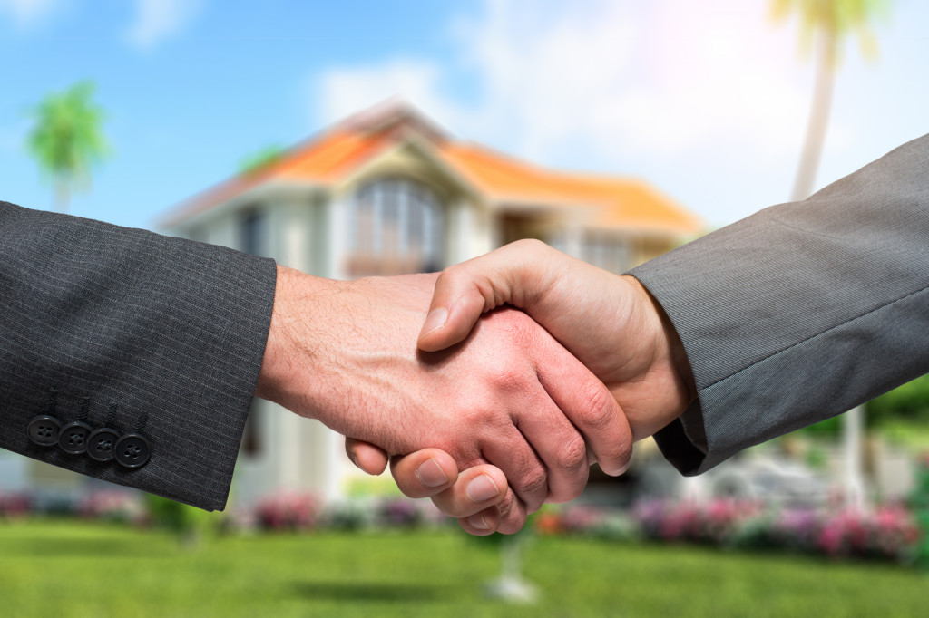 People shaking hands in a real estate transaction